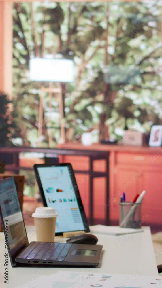 Vertical Video Empty modern home workstation of an entrepreneur with laptop and tablet, financial analytics data studied for startup investment and development. Remote job in business industry.
