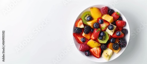 Fresh Fruit Salad Bowl on White Background with Copy Space, Shot from Above.