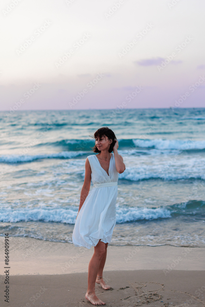 Happy traveler girl in a white summer dress enjoying a tropical paradise beach with turquoise sea. Happy traveler girl in a white summer dress enjoying a tropical paradise beach with turquoise sea.