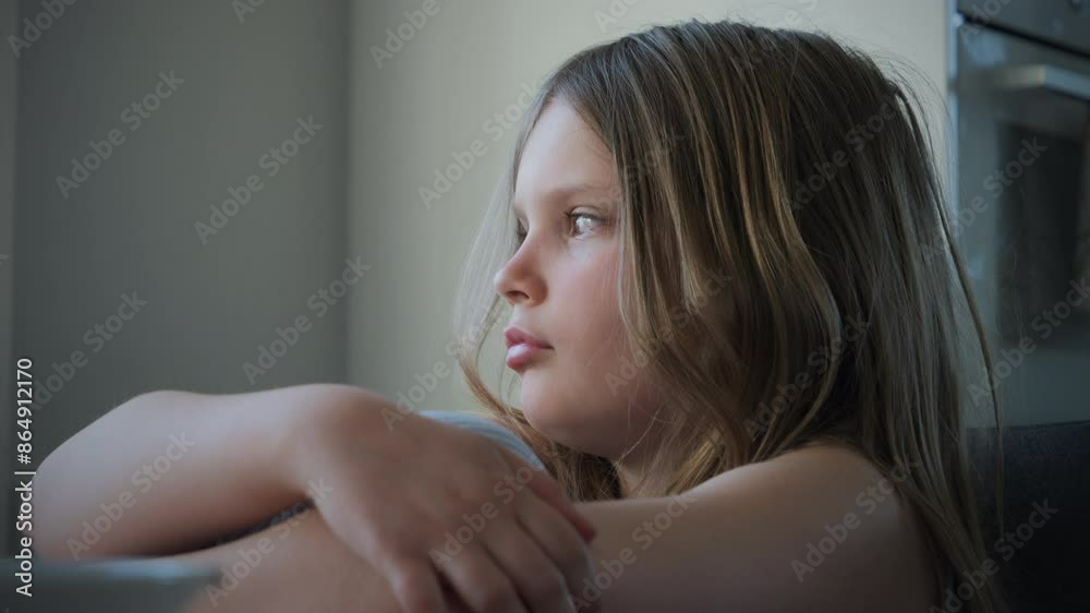 Portrait of cute little blonde girl pensive in the kitchen. Slow motion Portrait of cute little blonde girl pensive in the kitchen. Slow motion