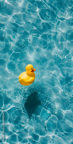 Single yellow rubber duck floating in a blue pool. Bright and playful summer scene.