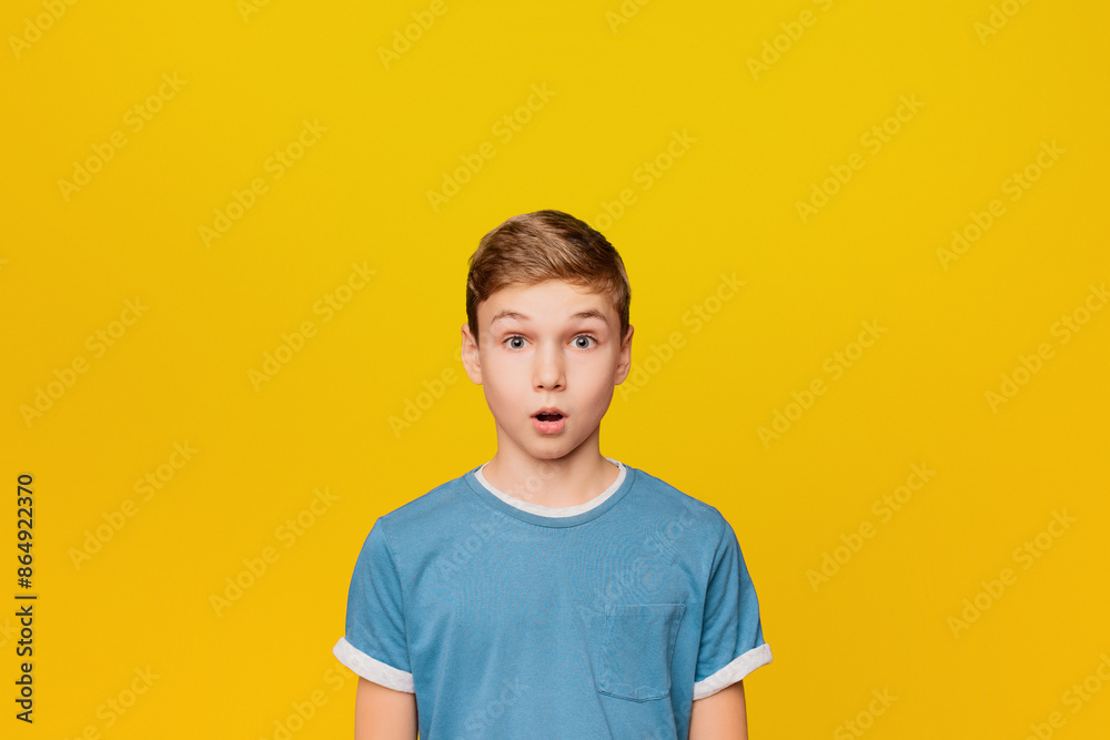 Portrait of stunned shocked little boy on orange studio background Portrait of stunned shocked little boy on orange studio background