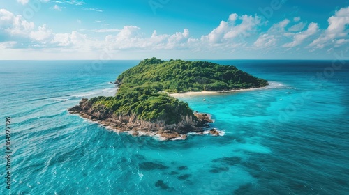 Isolated island encompassed by vast crystal clear blue ocean beside the shore
