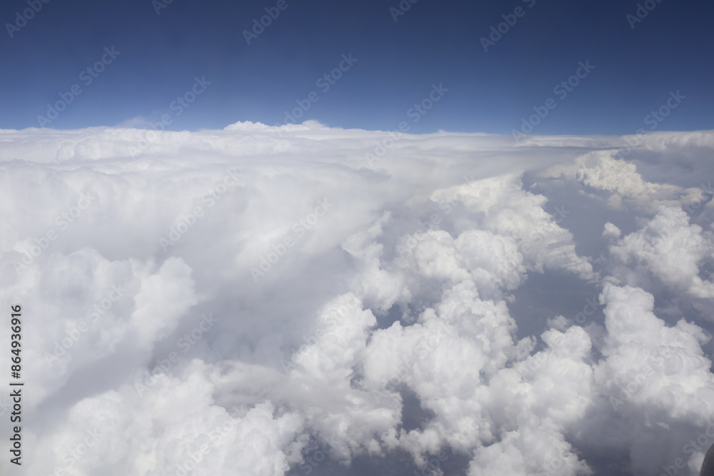 View of beautiful sky in sunny day above clouds from an airplane View of beautiful sky in sunny day above clouds from an airplane