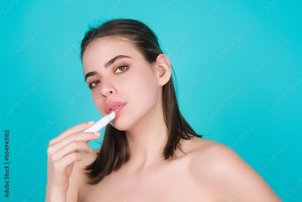 Beautiful young woman applying red lipstick on lips, studio color background. Sexy girl applied lipstick. Young nodel holding pink lipstick. Red lips make up. Beautiful woman putting lipstick on lips. Beautiful young woman applying red lipstick on lips, studio color background. Sexy girl applied lipstick. Young nodel holding pink lipstick. Red lips make up. Beautiful woman putting lipstick on lips.