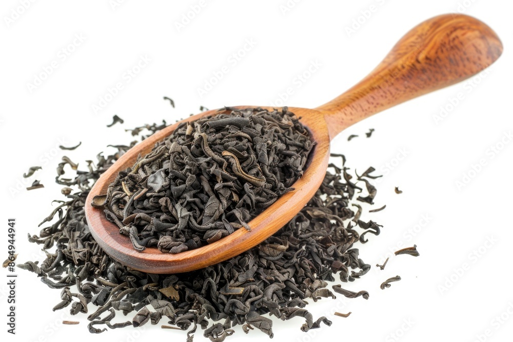 A wooden spoon filled with black tea leaves ready for brewing A wooden spoon filled with black tea leaves ready for brewing