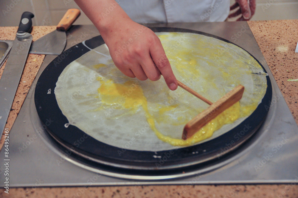 Making pancake rolled with crisp fritter, traditional Chinese food, street snacks,