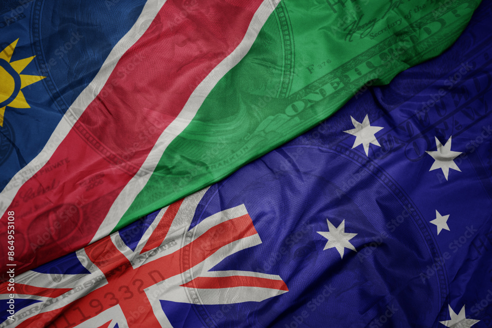 waving colorful flag of namibia and national flag of australia on the dollar money background. finance concept.