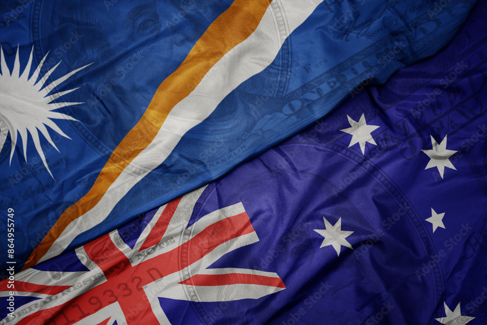 waving colorful flag of Marshall Islands and national flag of australia on the dollar money background. finance concept.