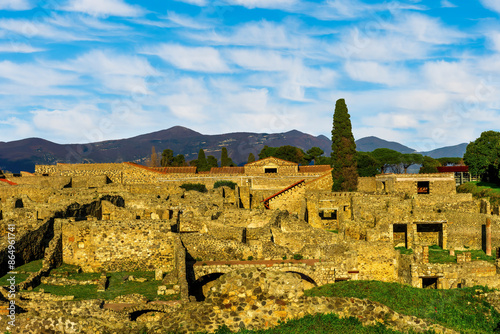 panoramic view of Pompeii ruins in Italy near Naples uotdoor under blue cloudy sky. Landscape of ancient historical town of Roman empire with beautiful valley and mountains on background photo