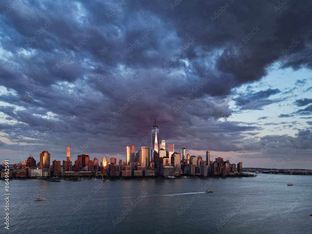 Naklejka premium NYC, New York City Skyline with dramatic sky. American Urban Skyscrapers USA near dramatic clouds. New York City skyline, cityscape of Manhattan in USA. Panoramic view on Manhattan. USA.
