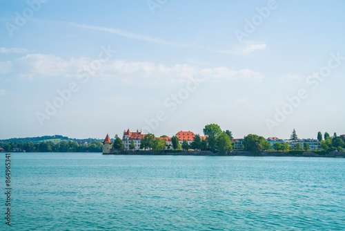 Germany, Lindau island houses view from waterside nature landscape reflecting in silent bodensee lake water early in the morning