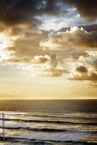 Seascape with large golden clouds at sunset. Tenerife, Spain.