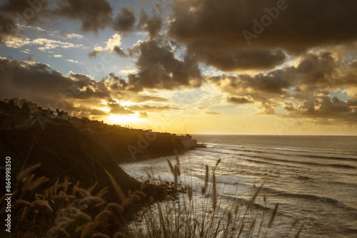 Seascape with large golden clouds at sunset. Tenerife, Spain.