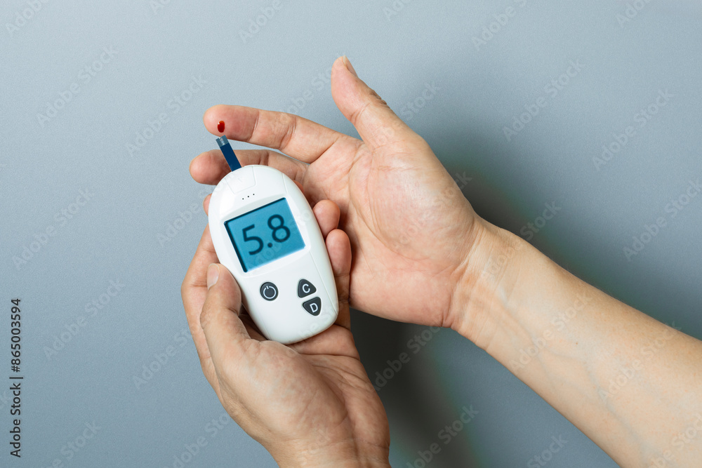 hand of people check diabetes and high blood glucose monitor with digital pressure gauge. Healthcare and Medical concept hand of people check diabetes and high blood glucose monitor with digital pressure gauge. Healthcare and Medical concept