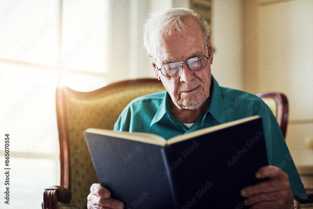 Elderly man, reading and fantasy book in home, literature and language for learning in retirement. Old person, fiction and textbook for knowledge to relax on sofa, glasses and studying information Elderly man, reading and fantasy book in home, literature and language for learning in retirement. Old person, fiction and textbook for knowledge to relax on sofa, glasses and studying information