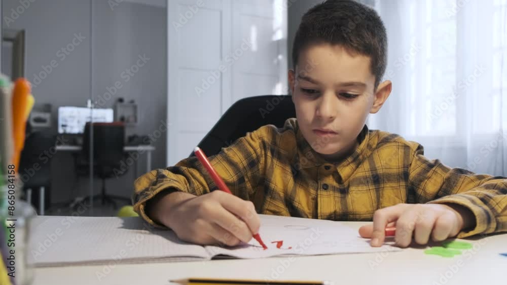 young boy drawing on paper at home young boy drawing on paper at home