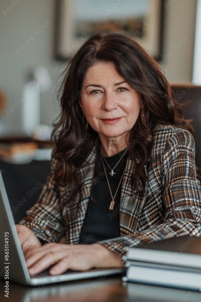 A person sitting in front of a laptop, likely working or studying A person sitting in front of a laptop, likely working or studying