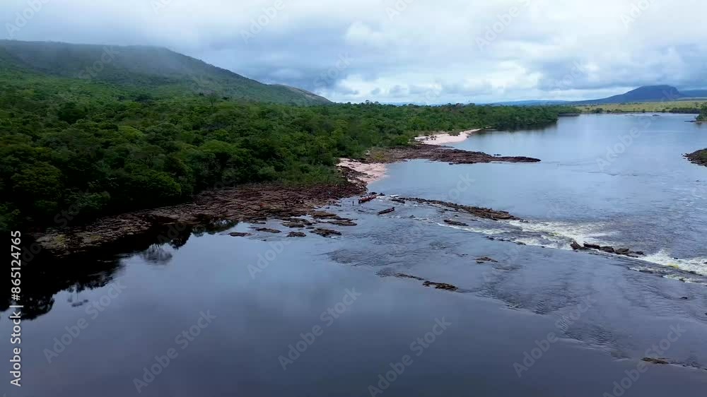 Aerial view of the boat crossing over the rocks of the carrao river Aerial view of the boat crossing over the rocks of the carrao river
