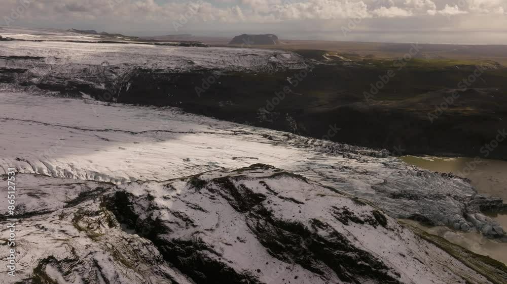 Aerial revealing shot of the Sólheimajökul glacier melting in Iceland Aerial revealing shot of the Sólheimajökul glacier melting in Iceland