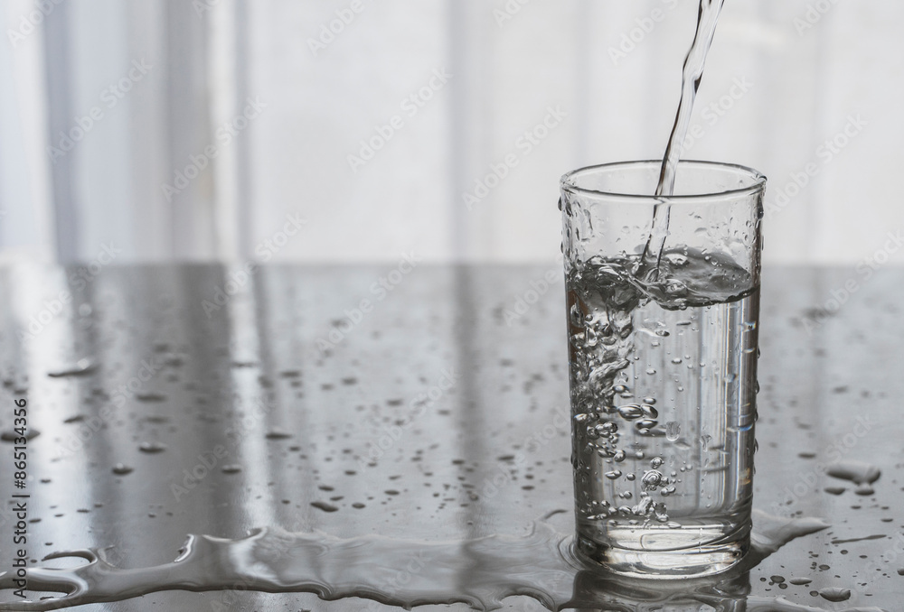 Background image with a glass of water. Pouring water into the glass Background image with a glass of water. Pouring water into the glass