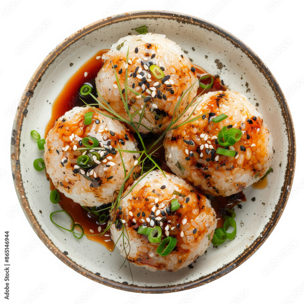 A plate of Japanese yaki onigiri, grilled rice balls brushed with soy sauce, garnished with sesame seeds and green onions, isolated on white background. A plate of Japanese yaki onigiri, grilled rice balls brushed with soy sauce, garnished with sesame seeds and green onions, isolated on white background.