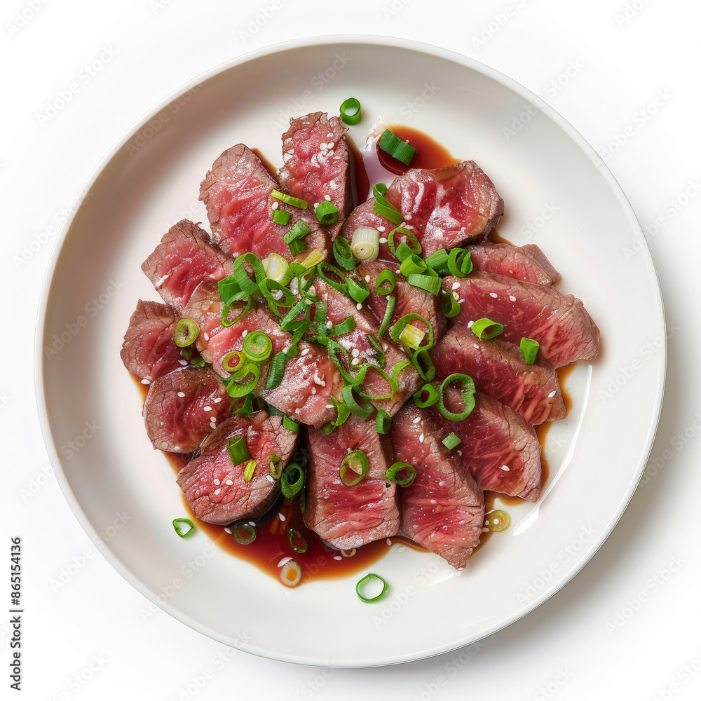 A plate of Japanese beef tataki, lightly seared and thinly sliced beef, served with ponzu sauce and garnished with green onions, isolated on white background. A plate of Japanese beef tataki, lightly seared and thinly sliced beef, served with ponzu sauce and garnished with green onions, isolated on white background.