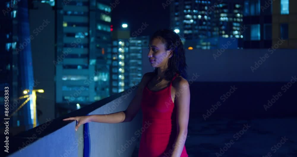 A Hispanic girl on a rooftop with the lights of Port of Spain, Trinidad illuminating the Caribbean background. A Hispanic girl on a rooftop with the lights of Port of Spain, Trinidad illuminating the Caribbean background.