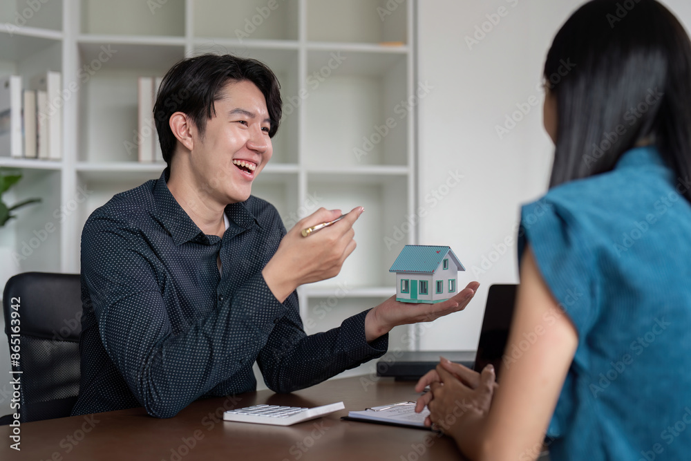 Real Estate Agent Discussing Property Sale with Client, Signing Documents, Buy and Sell Homes Real Estate Agent Discussing Property Sale with Client, Signing Documents, Buy and Sell Homes
