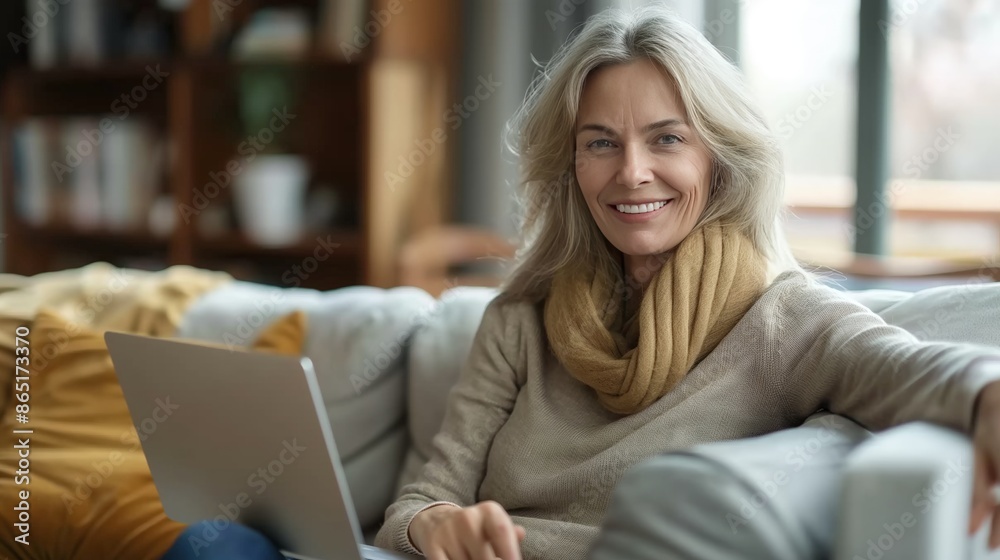 Smiling Woman Relaxing on Couch with Laptop at Home Smiling Woman Relaxing on Couch with Laptop at Home