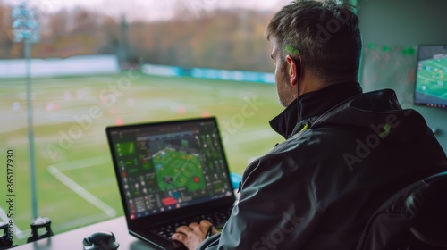 Strategizing Success Sports Coach Analyzing Game Plans with Laptop and Tactical Board in Fieldside Office photo