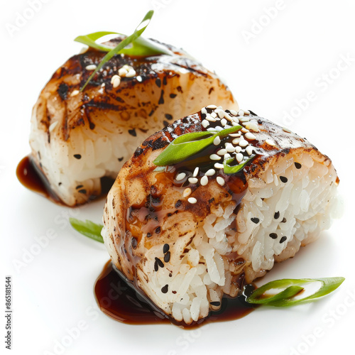 A traditional Japanese yaki onigiri, grilled rice balls brushed with soy sauce, garnished with sesame seeds and green onions, isolated on white background. photo