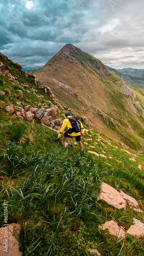 Facing the challenge of Aguerri Peak, a brave man ascends the trails, surrounded by the breathtaking scenery of the Oza Forest and the peaks of the Western Valleys. photo