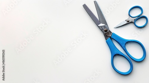 Blue handled school scissors on white background Central layout Overhead view with space for text