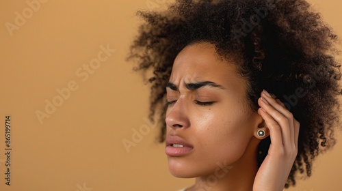 a woman with a headache on a beige background