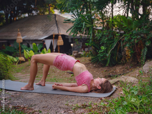 Beautiful woman practices yoga in Crabi, Thailand photo