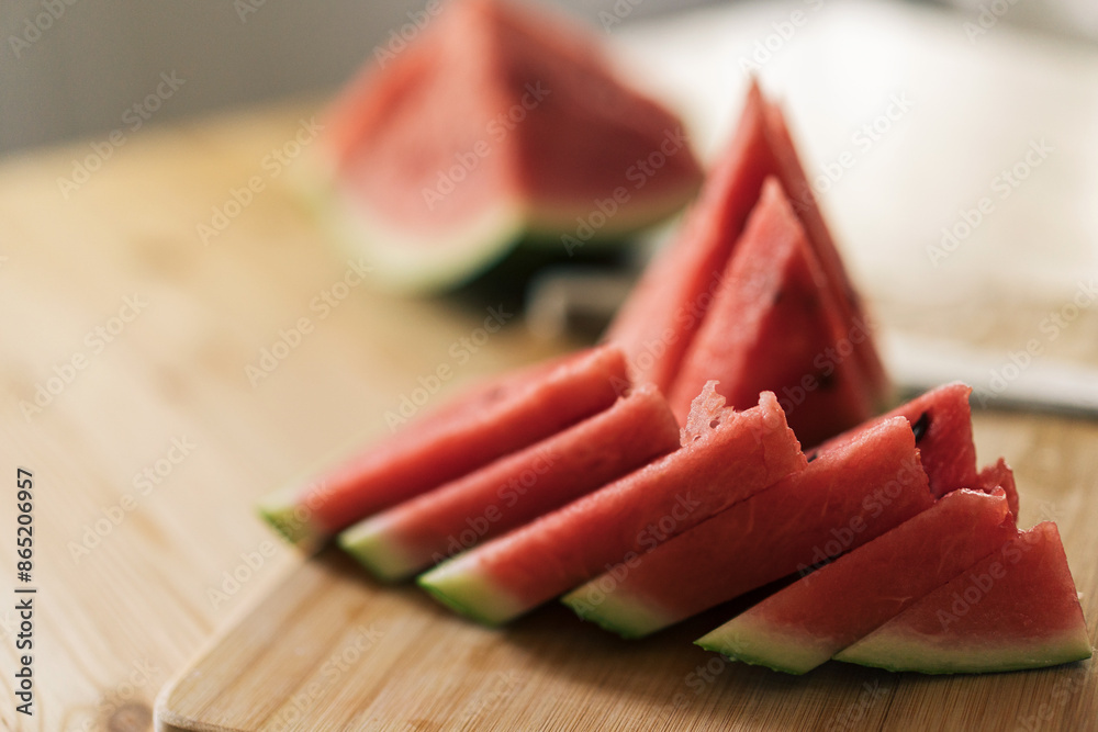 Triangular pieces of watermelon on a wooden cutting board. Triangular pieces of watermelon on a wooden cutting board.