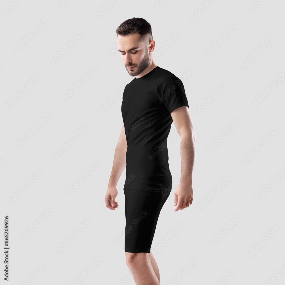 Template of men's black t-shirt, bike shorts on athletic bearded guy, sportswear, side view, for design, branding, advertising. Template of men's black t-shirt, bike shorts on athletic bearded guy, sportswear, side view, for design, branding, advertising.