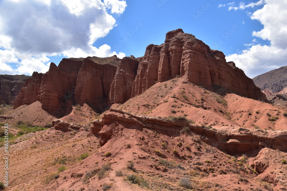 The red sandstone cliffs, canyons and valleys of Kyrgyzstan in Central Asia The red sandstone cliffs, canyons and valleys of Kyrgyzstan in Central Asia