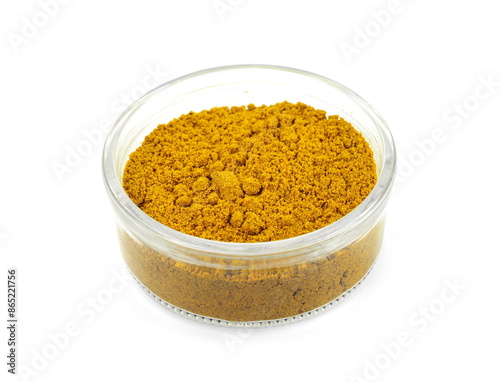 curry powder in a flass bowl isolated on white background photo