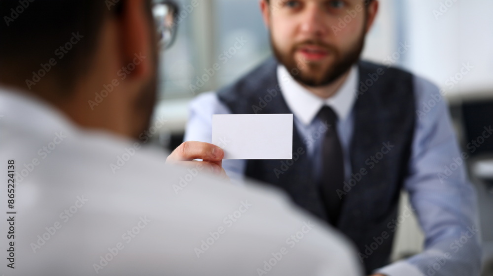 Male arm in suit give blank calling card to visitor closeup. White collar colleagues company name exchange job interview sale clerk id executive or ceo finance support formal identity etiquette Male arm in suit give blank calling card to visitor closeup. White collar colleagues company name exchange job interview sale clerk id executive or ceo finance support formal identity etiquette
