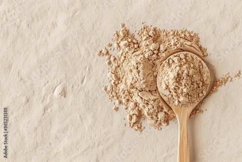 Close-Up View of Transparent Protein Powder on a Wooden Spoon Against a Minimalistic Background photo