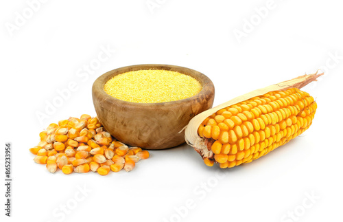 Картината върху платно Corn meal polenta in wooden bowl and dry corn cobs and grains isolated on white background