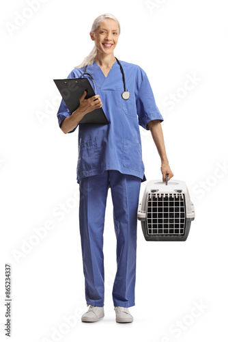 Female veterinarian holding a pet arrier and a clipboard photo