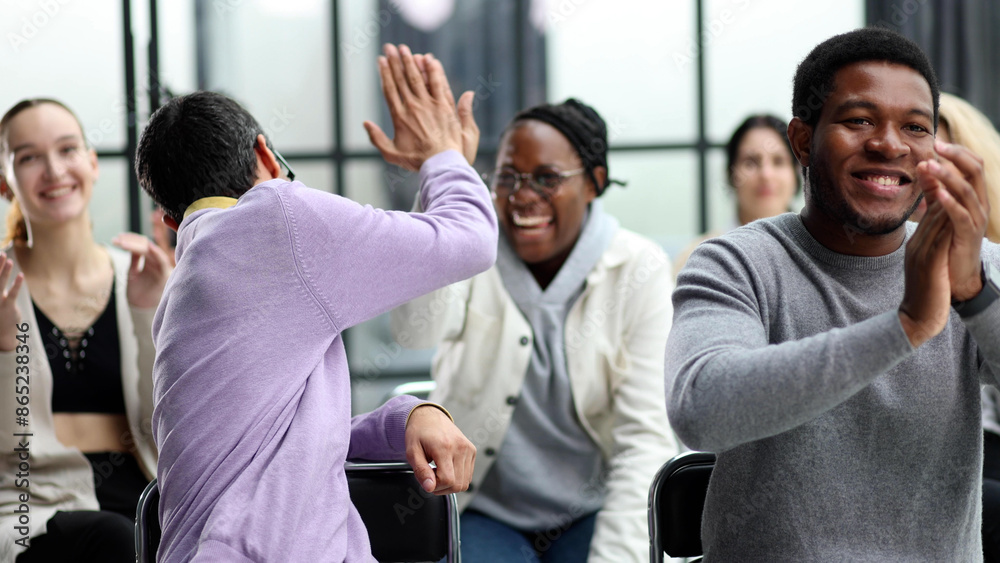 Business colleagues are sitting during a meeting shaking hands Business colleagues are sitting during a meeting shaking hands