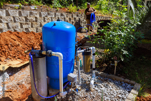 PVC pipe in trench ready to be connected to home well water system photo