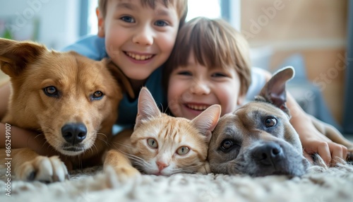 A smiling boy takes a selfie with a pet cat and dog