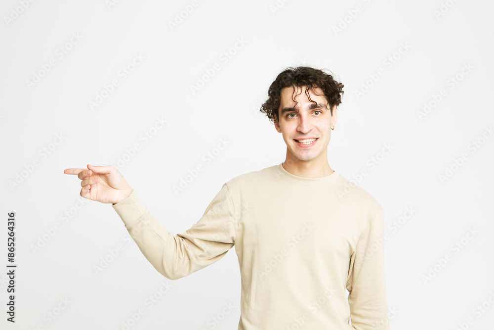 Young man shows something with finger up over white background. Young man shows something with finger up over white background.