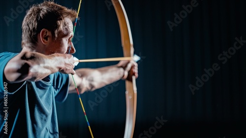 focused archer preparing to shoot arrow in competition.