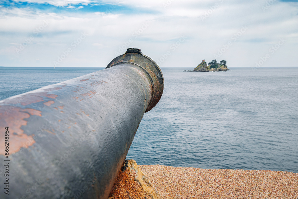 Historic cannon at Kastio Fortress in Petrovac, Montenegro, overlooking the Adriatic Sea. Historic cannon at Kastio Fortress in Petrovac, Montenegro, overlooking the Adriatic Sea.